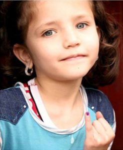 Girl proudly displaying her marked finger, indicating that she has been vaccinated against polio. © Unicef